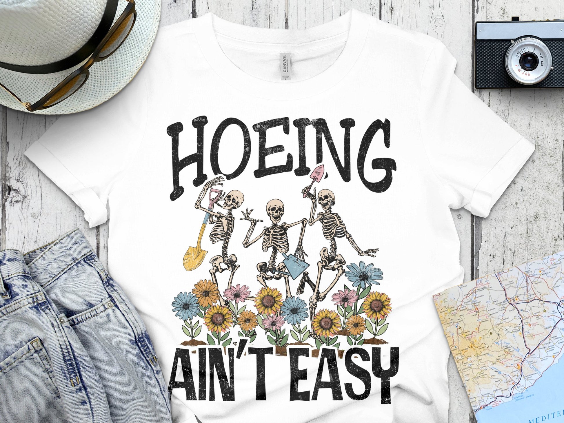 Skeleton Garden T-Shirt, Hoeing Ain't Easy Funny Gardening Tee, Floral Skull Graphic, Unisex Cotton Shirt for Gardeners