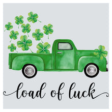 a green truck with shamrocks in the bed of it