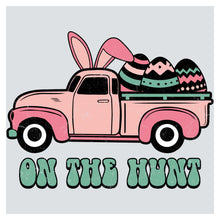a pink truck with an easter egg in the back