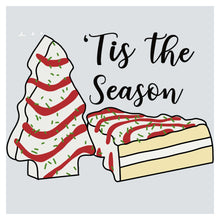 a piece of cake sitting next to a christmas tree